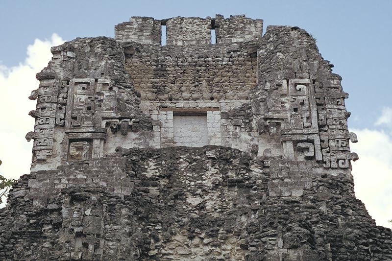 Chicanná, Structure XX upper story showing front view with fallen serpent-mouth entrance and roof comb