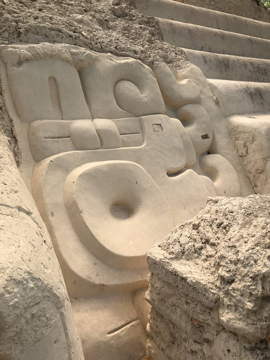 The re-stuccoed and restored jaguar paw that forms part of the giant masks flanking the upper stair of Jaguar Paw Temple(Structure 34), El Mirador