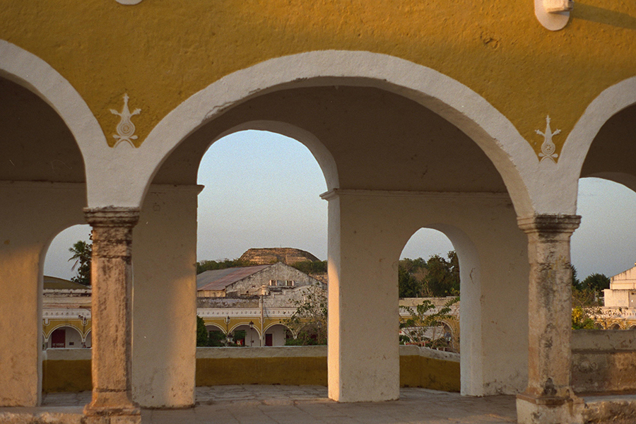 Izamal: View of Kinich Kak Mo through the arches of Basilica of San Antonio de Padua