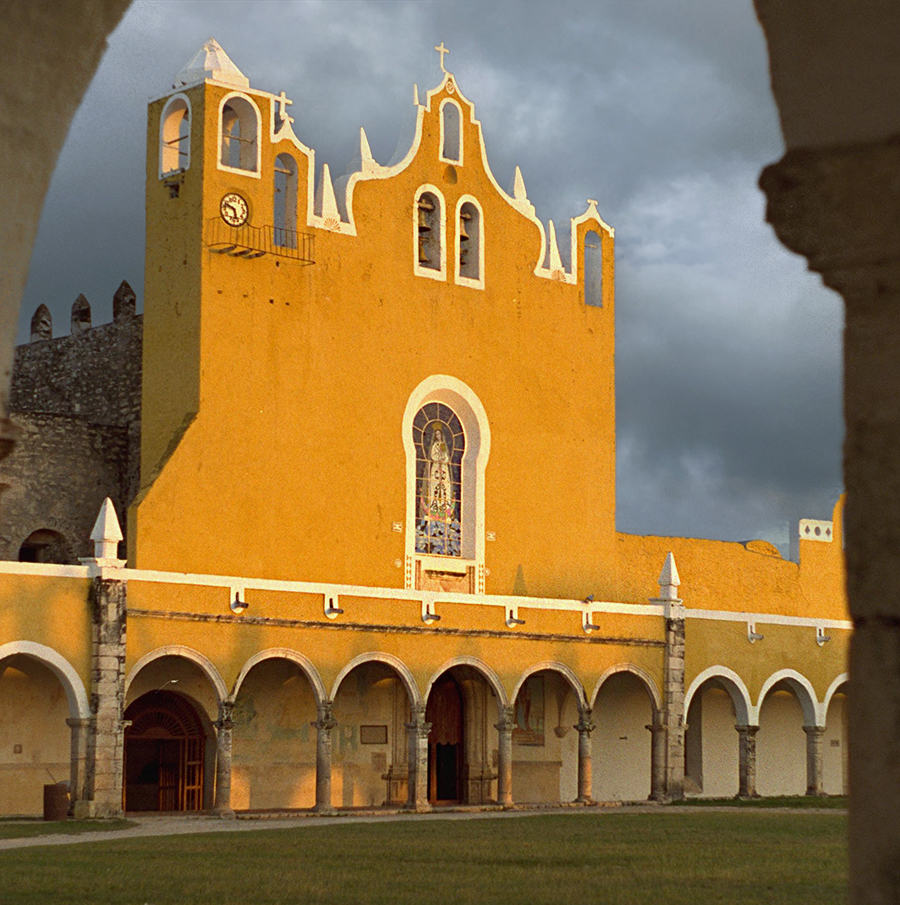 Izamal: Basilica of San Antonio de Padua showing colonnade, choir window, espadaña, side belfries and the 19th century bell tower