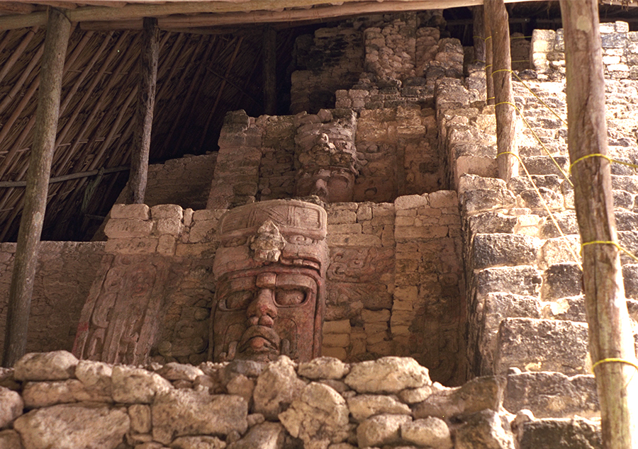 Column of masks on the left side of the stairway