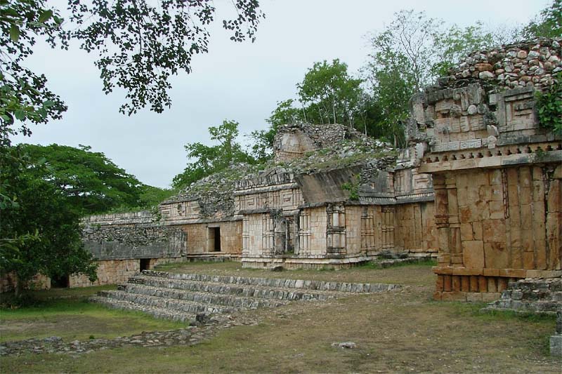 Central Patio of the Palace of Labna, showing the oldest building of the complex on the left, steps leading to the old throne room in the center, and part of the building containing the last throne room on the right