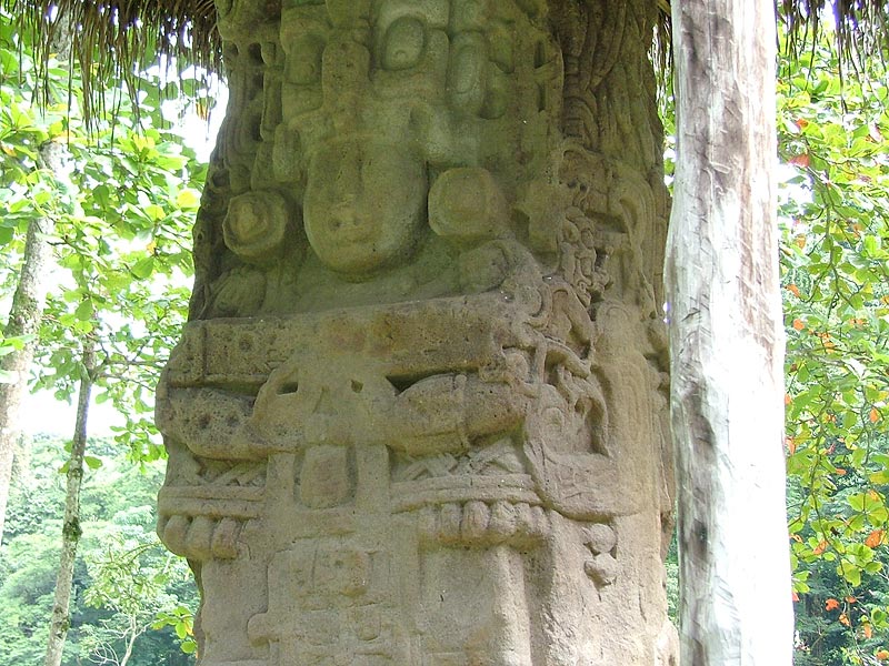 Detail of Cauac Sky holding the double-sided serpent bar on Stela H